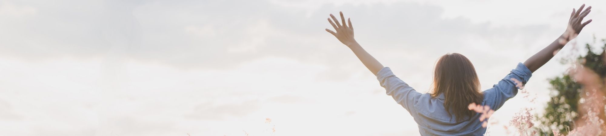 A happy woman with arms raised in joy after therapy at PRESENT Counseling in Chicago A happy woman with arms raised in joy after therapy at PRESENT Counseling in Chicago